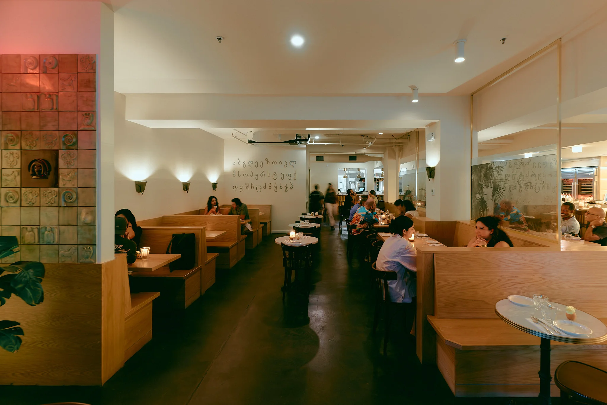 Cozy restaurant interior with wooden booths and warm lighting
