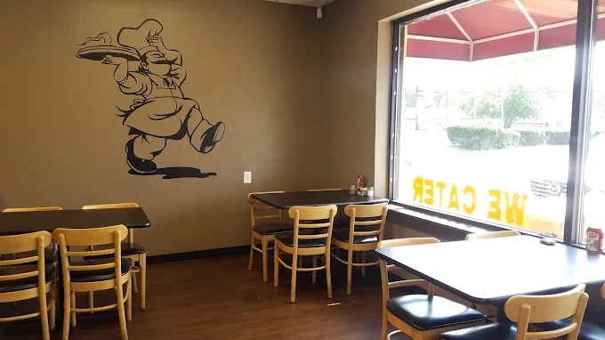 Cozy restaurant interior with wooden tables and playful wall art