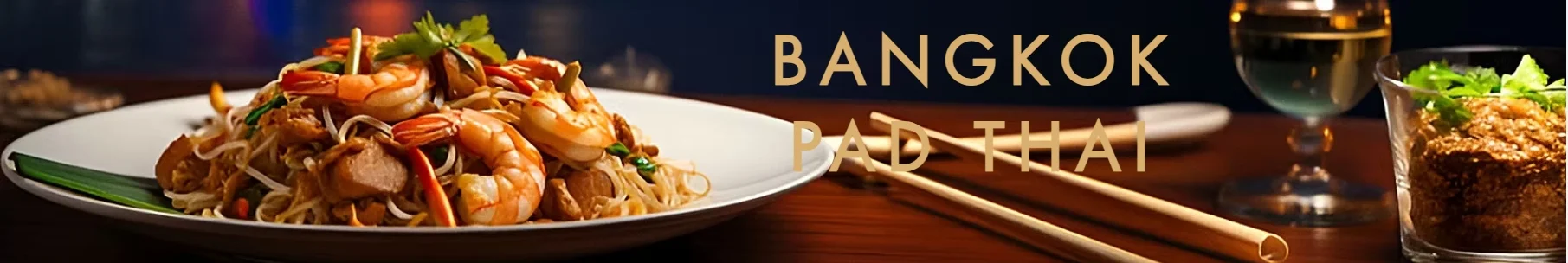 Plate of Pad Thai with shrimp, garnished with herbs and served with chopsticks.