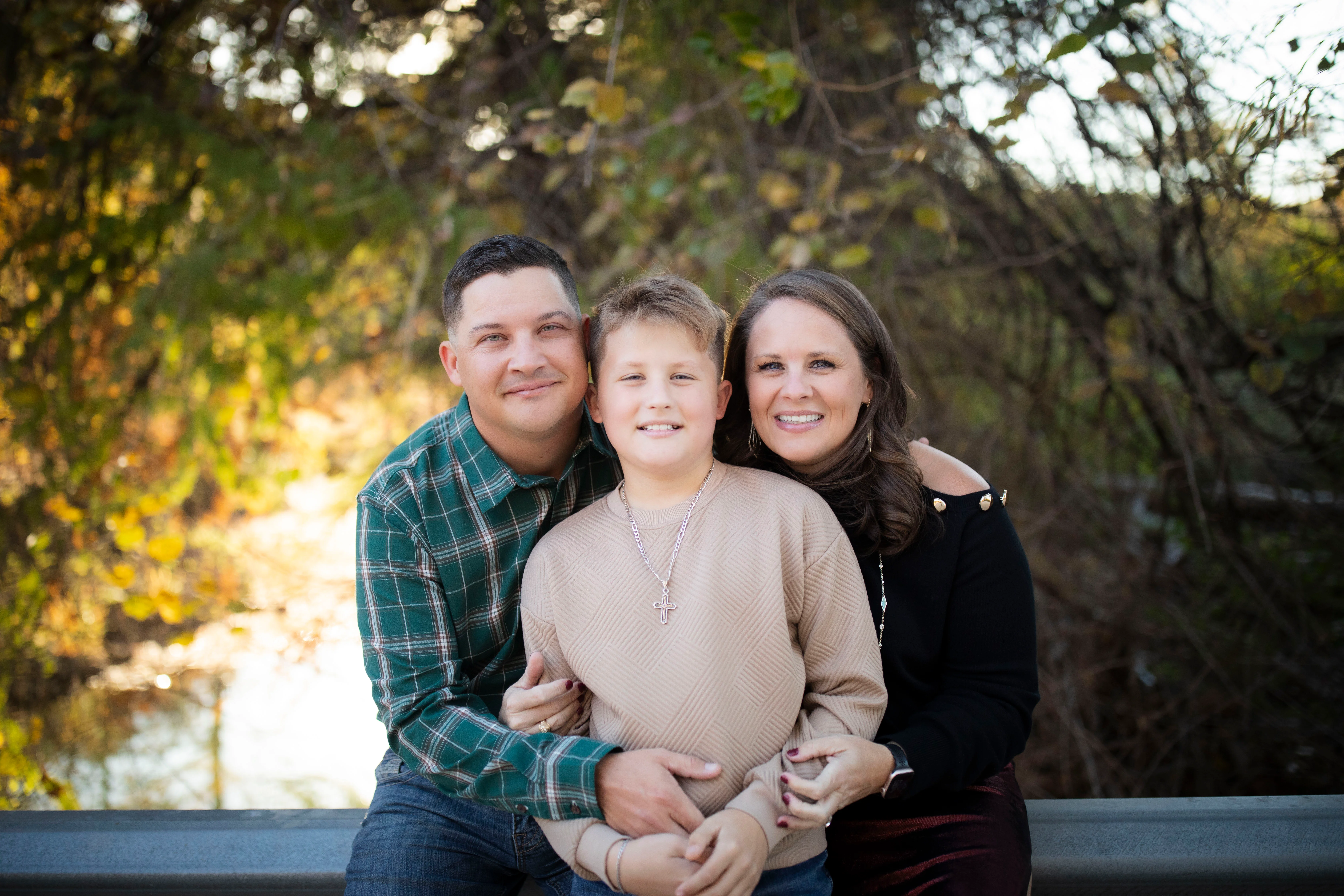 Family portrait outdoors with autumn foliage