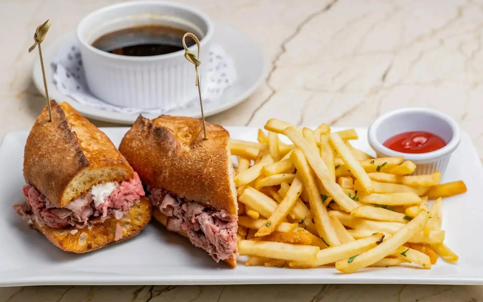 Classic French dip sandwich with fries and au jus