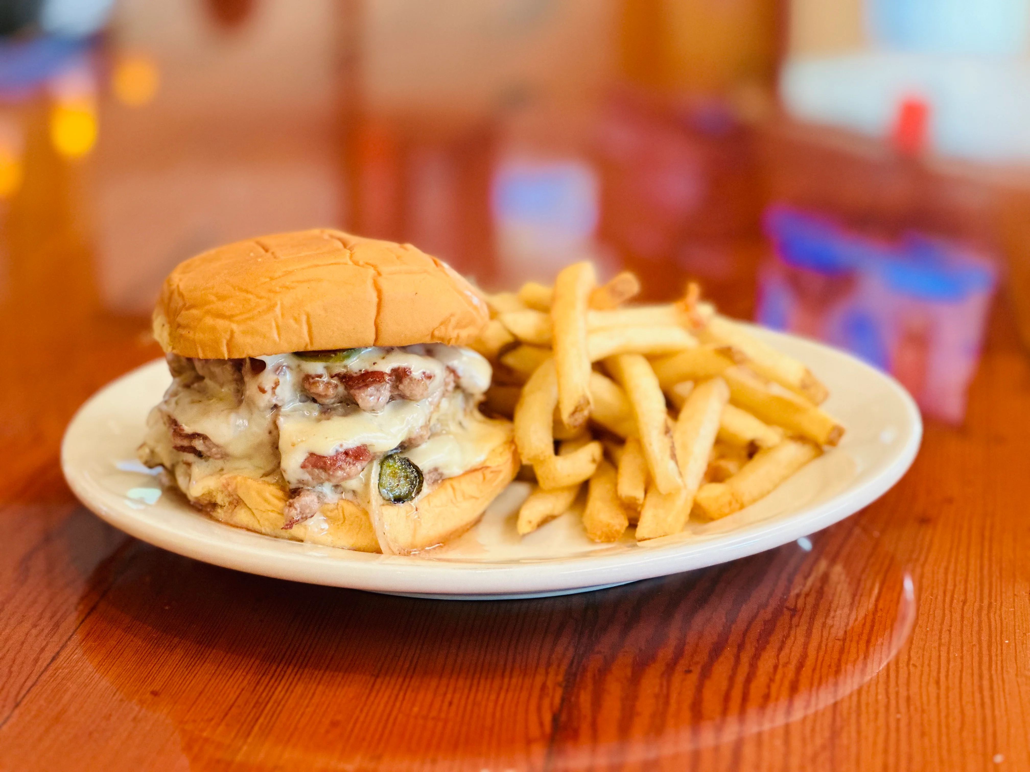 Juicy cheeseburger with fries on a plate