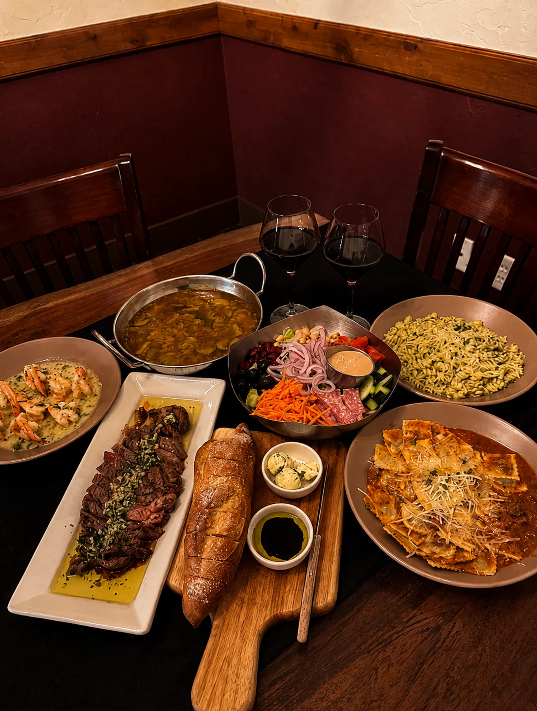 Assorted Mediterranean dishes with wine in a cozy restaurant setting