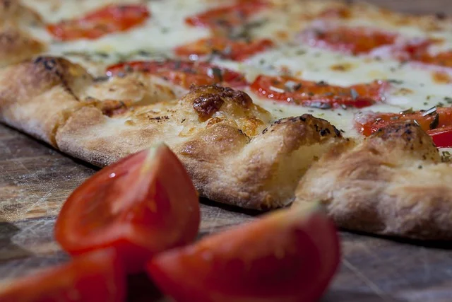 Fresh Margherita pizza with tomatoes and mozzarella