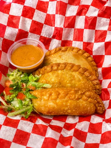 Crispy empanadas served with lime and dipping sauce
