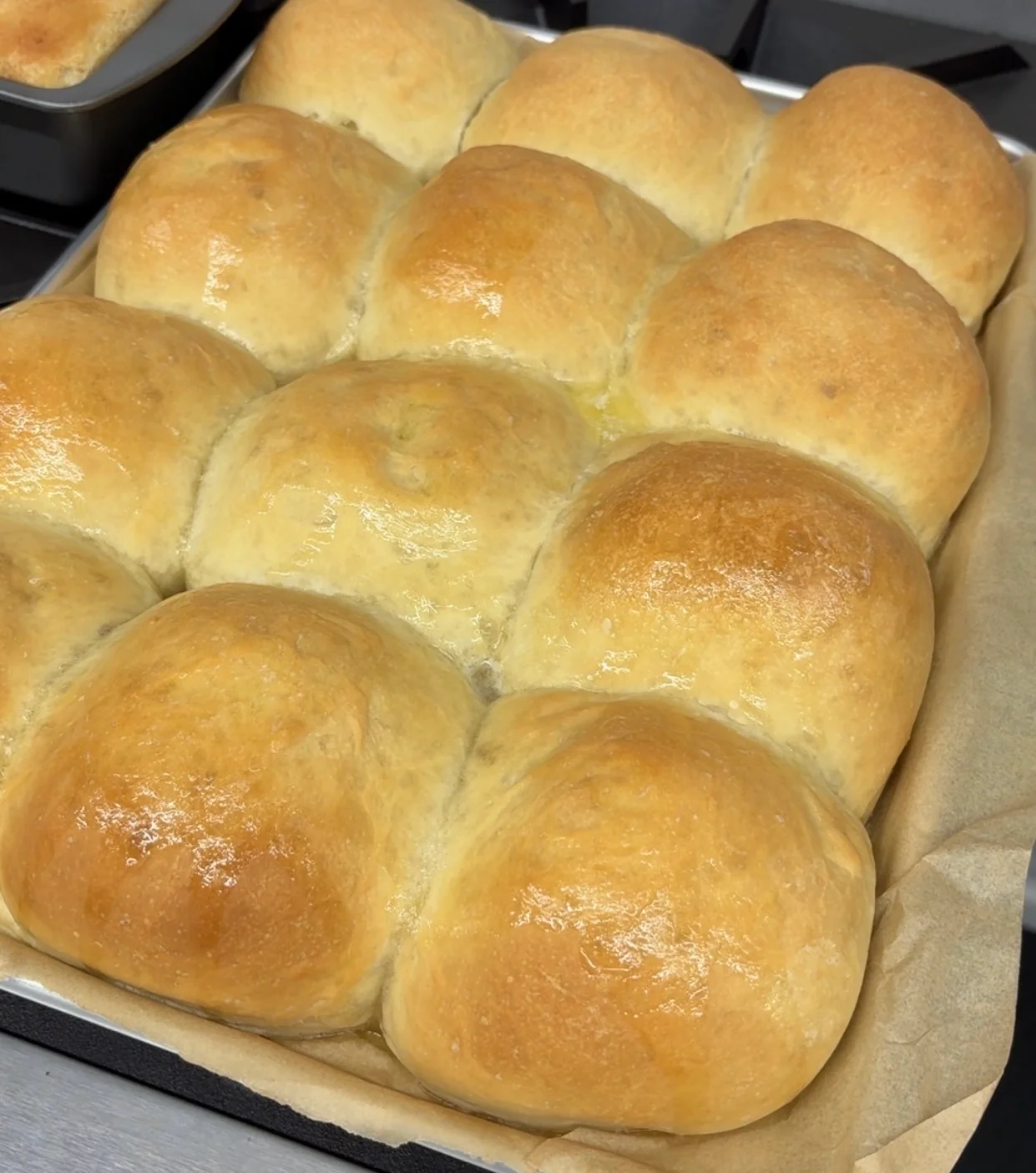 Freshly baked dinner rolls in a warm kitchen