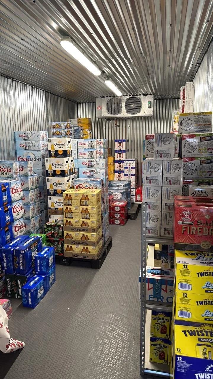 Well-organized beverage storage room with various beer brands