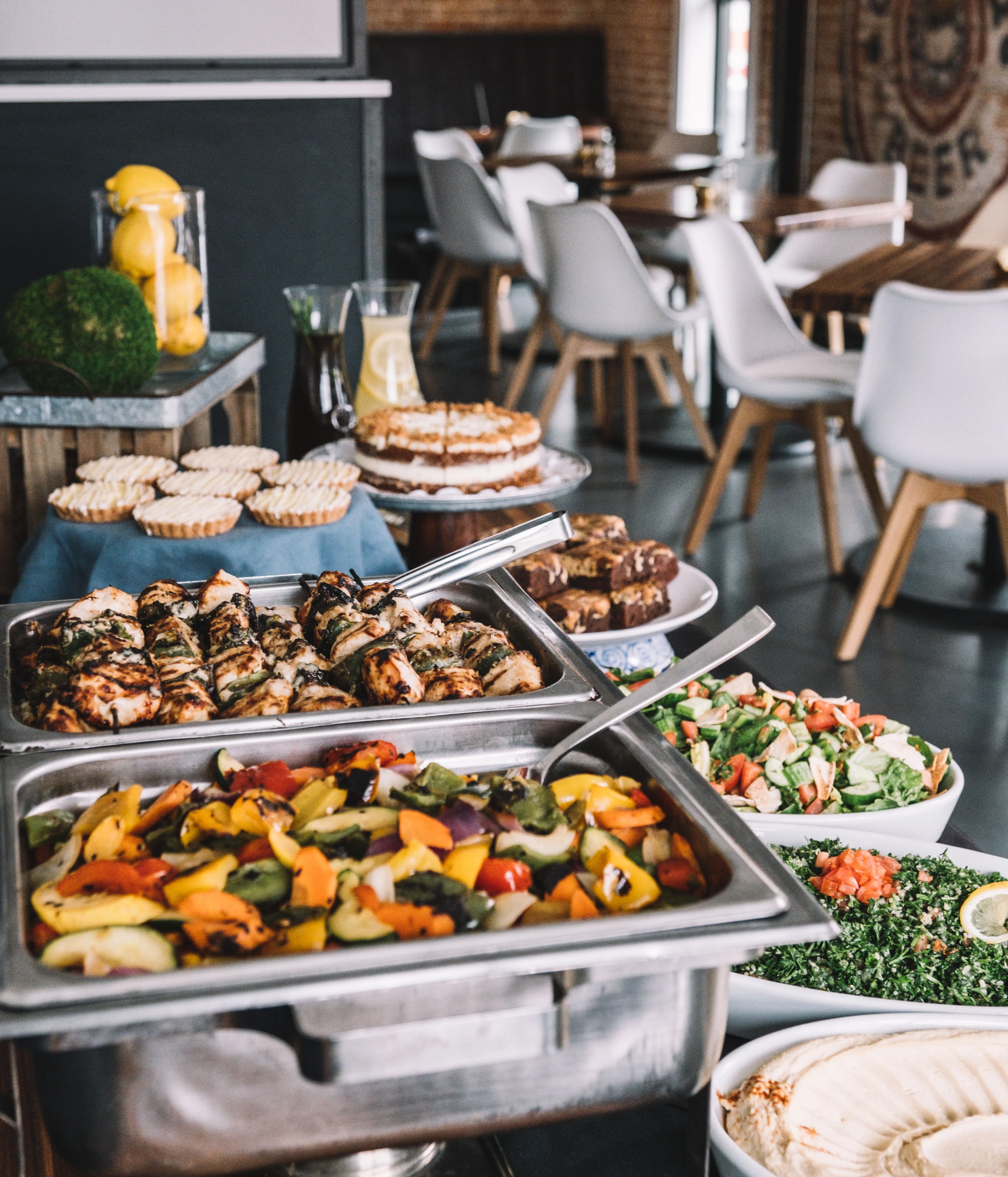 Mediterranean buffet with grilled chicken and colorful roasted vegetables