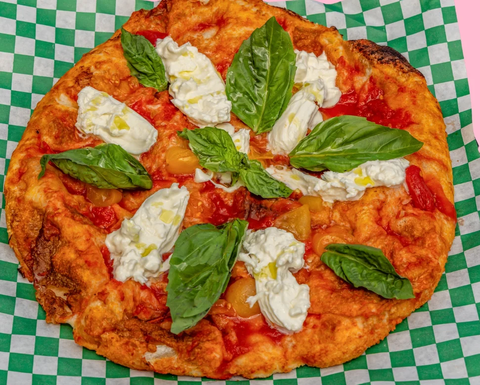 Margherita pizza with fresh basil and creamy mozzarella