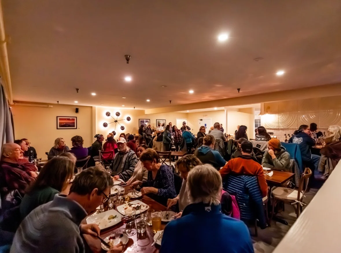 Cozy restaurant interior bustling with diners and warm lighting