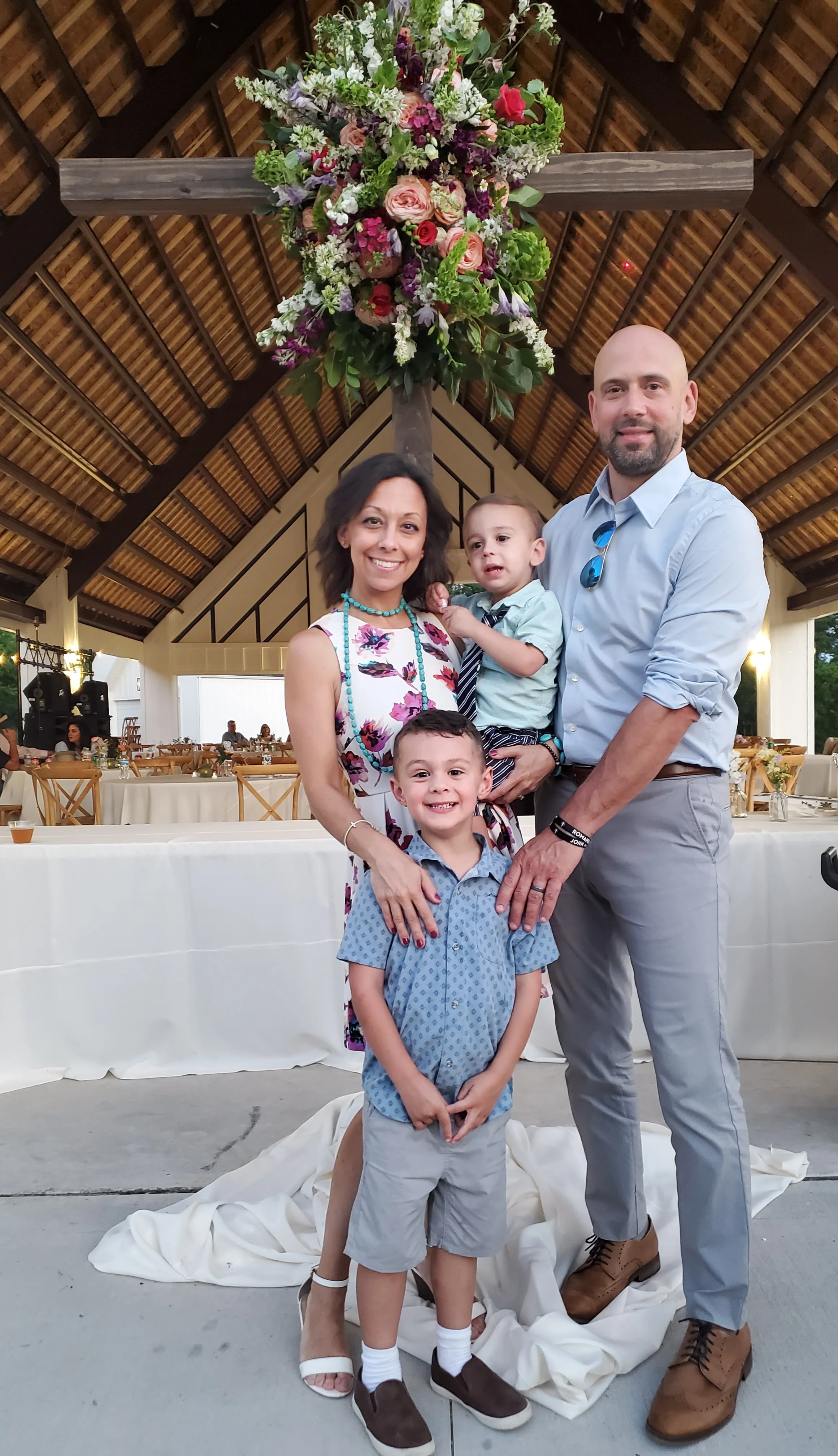 Family portrait at a festive event with floral decorations
