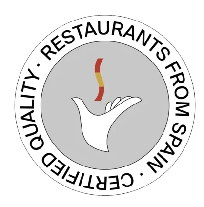Restaurants from Spain certification seal for Casa Juancho, with a stylized hand holding a red-and-yellow flame, representing authentic Spanish cuisine.