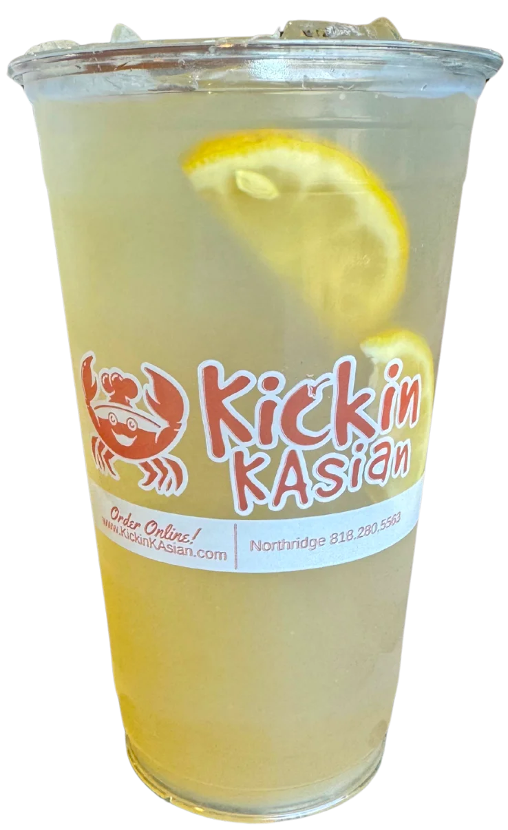 Refreshing lemonade in a clear cup with lemon slices