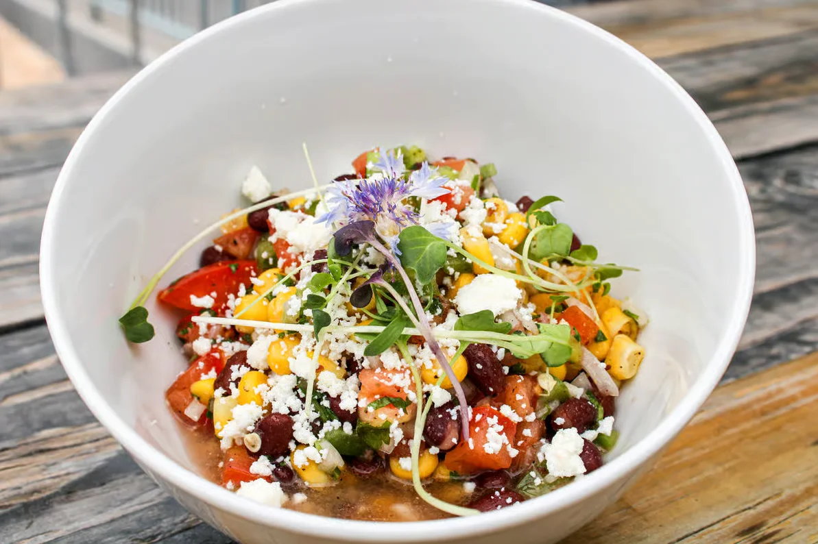Colorful Mexican bean salad in a white bowl