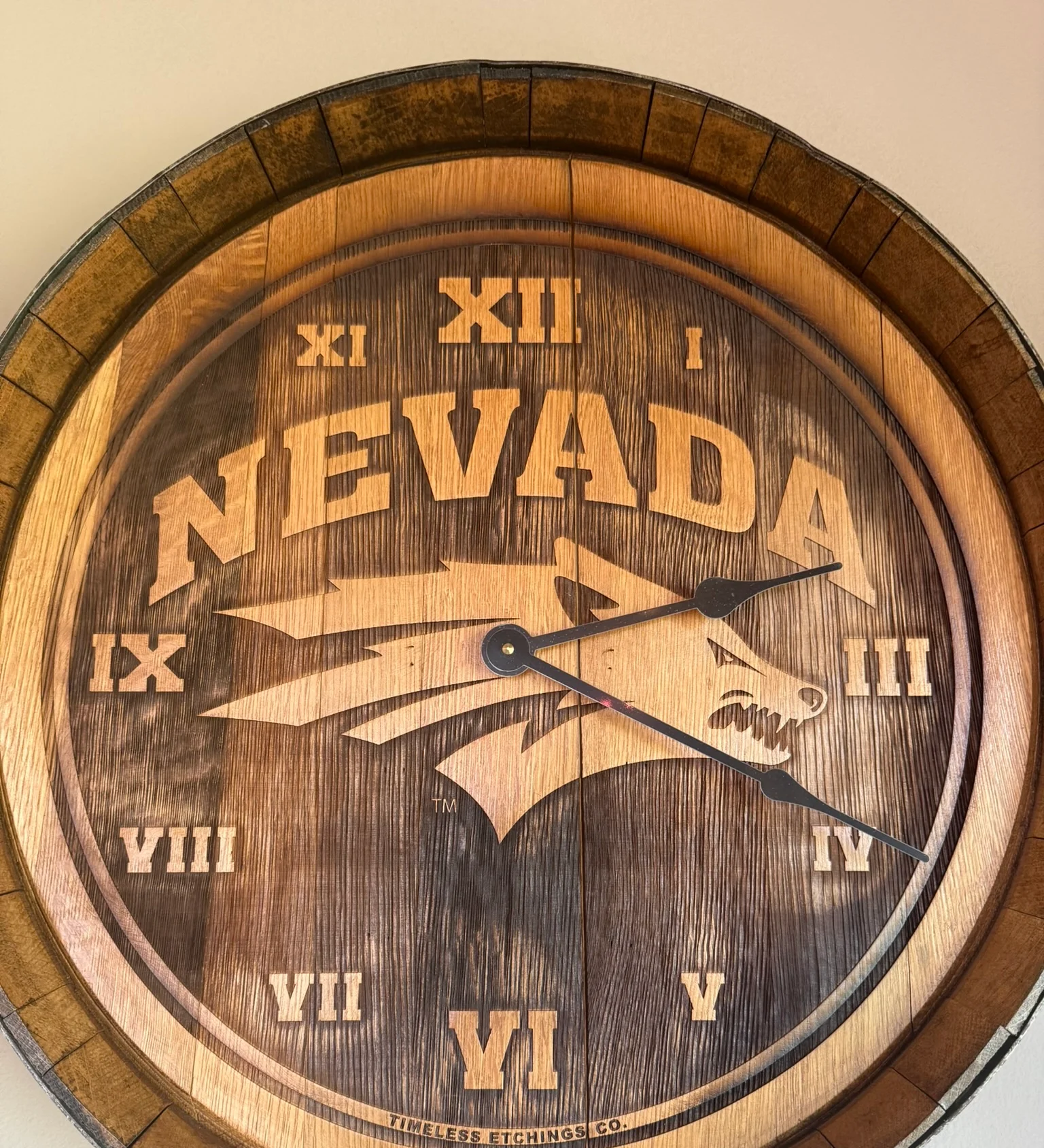 Wooden wall clock featuring Nevada design and wolf logo