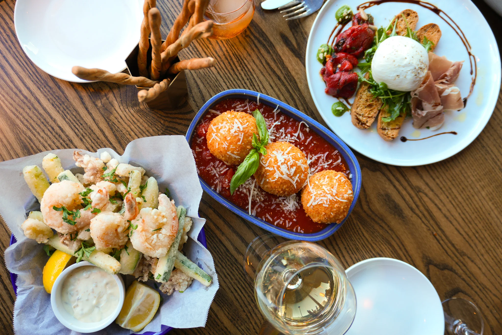 Italian arancini with marinara sauce and fried seafood platter