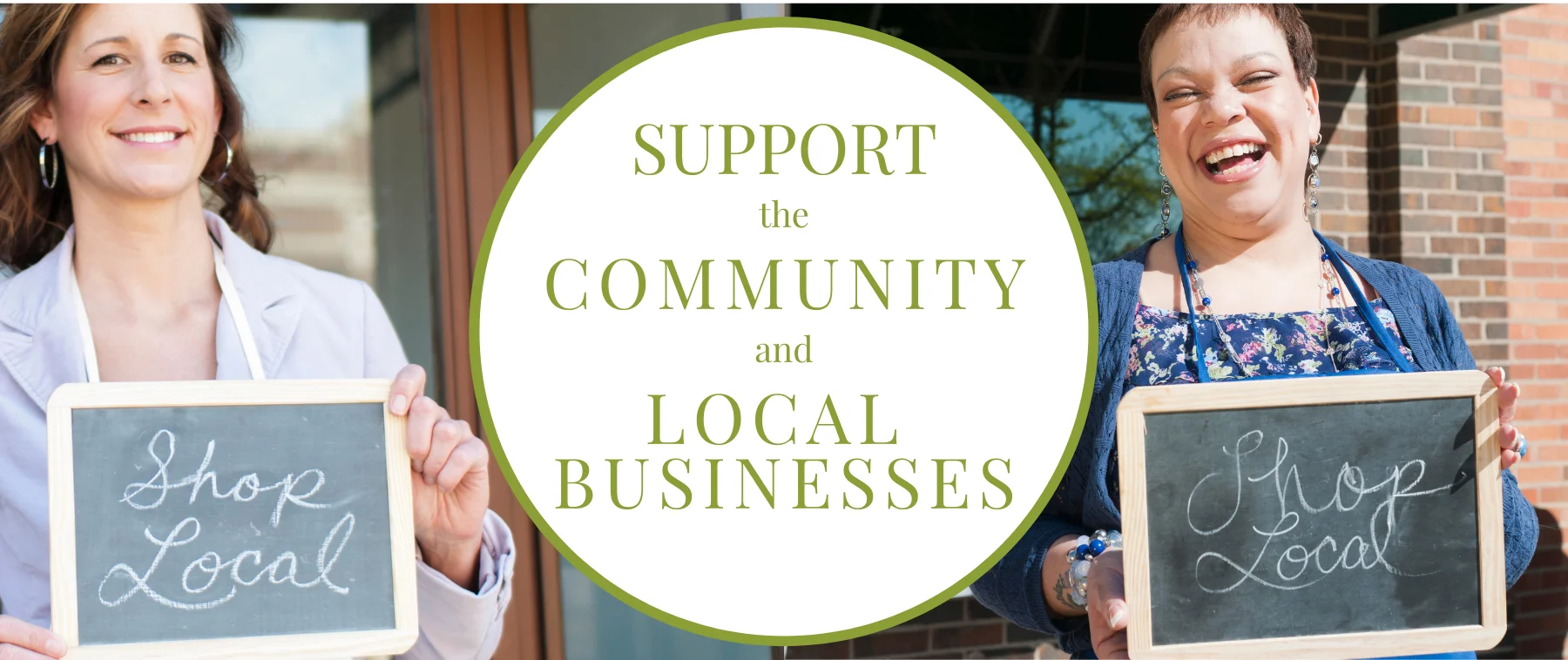 Two women promoting local businesses with chalkboards in a community setting