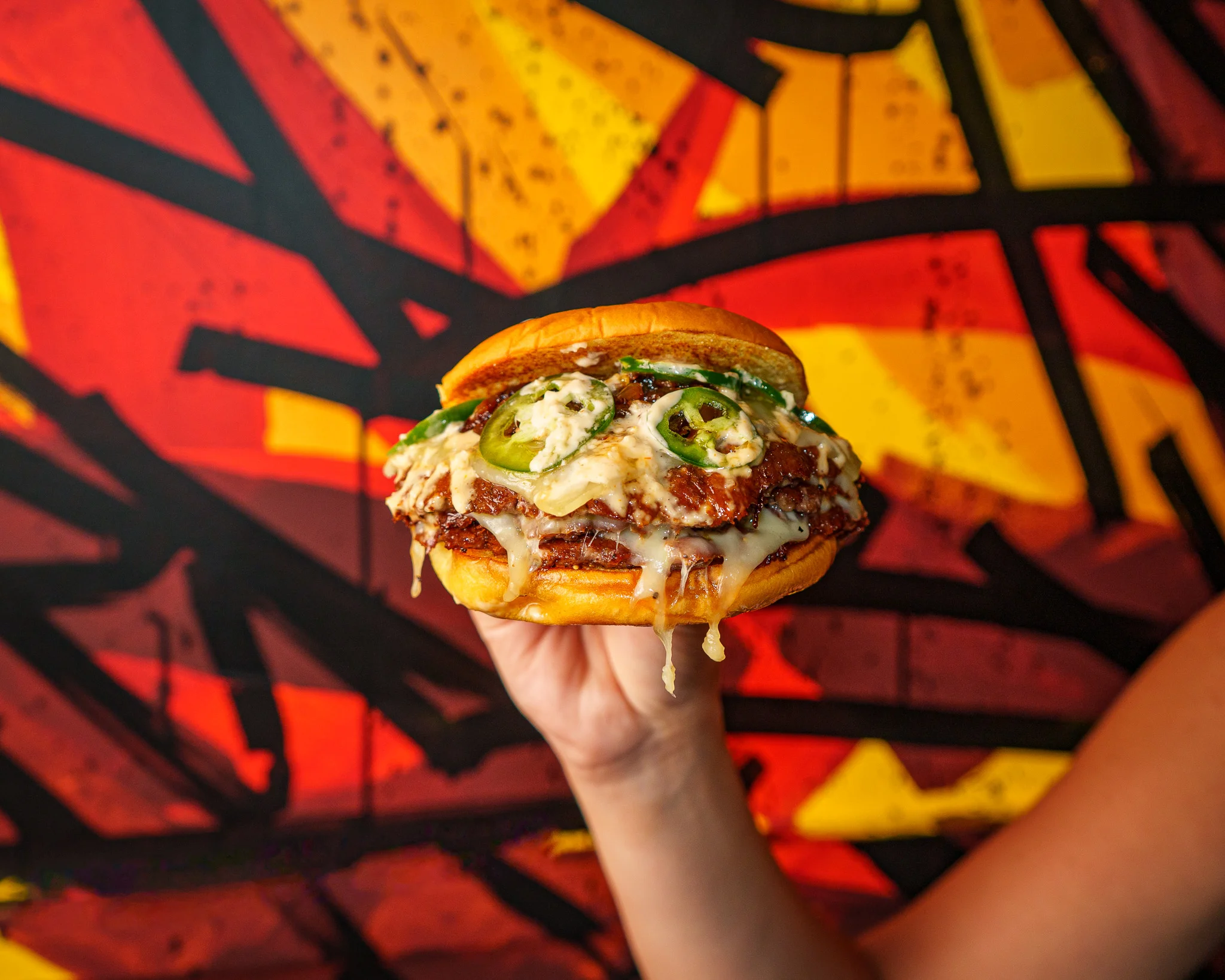 Stack of crispy fried chicken sandwiches with sauce and pickles