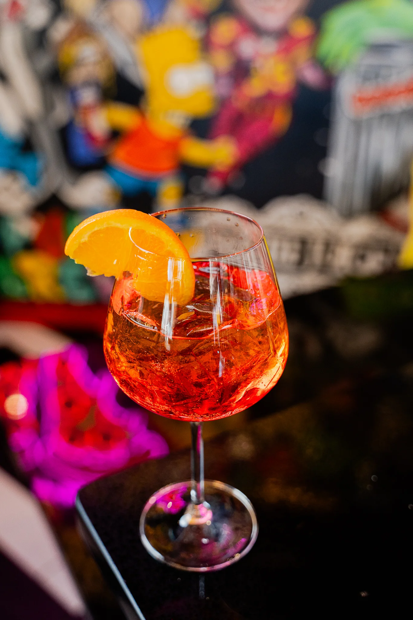 Colorful cocktails served in elegant glasses on a bar counter.