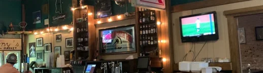 Cozy restaurant bar with warm lighting and sports on TV