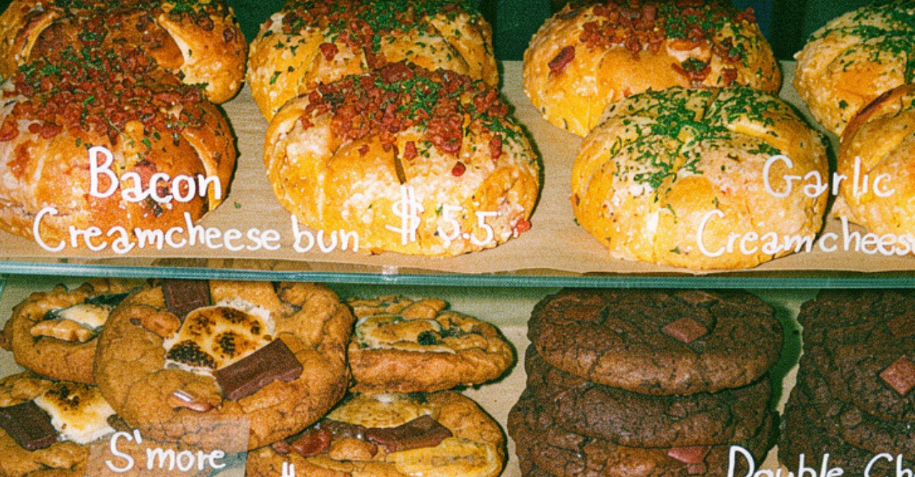 Assorted pastries including croissants and cookies in a bakery display