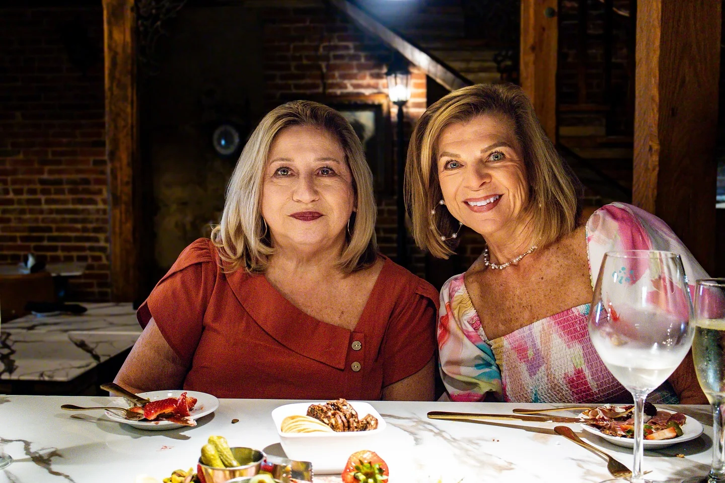 Two women enjoying a meal in a cozy restaurant setting