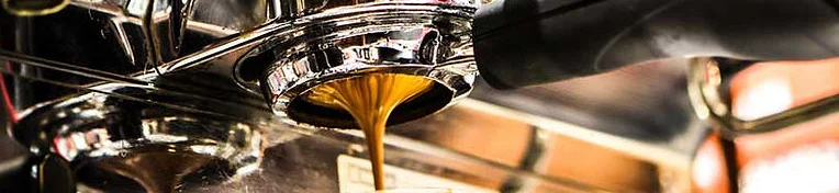 Espresso pouring from a coffee machine into a glass