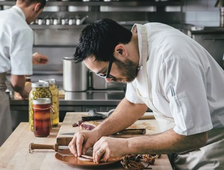 A restaurant chef preparing a dish