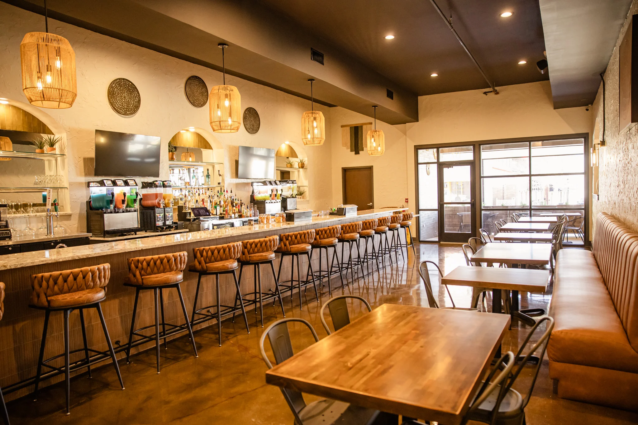 Modern restaurant interior with bar seating and warm lighting