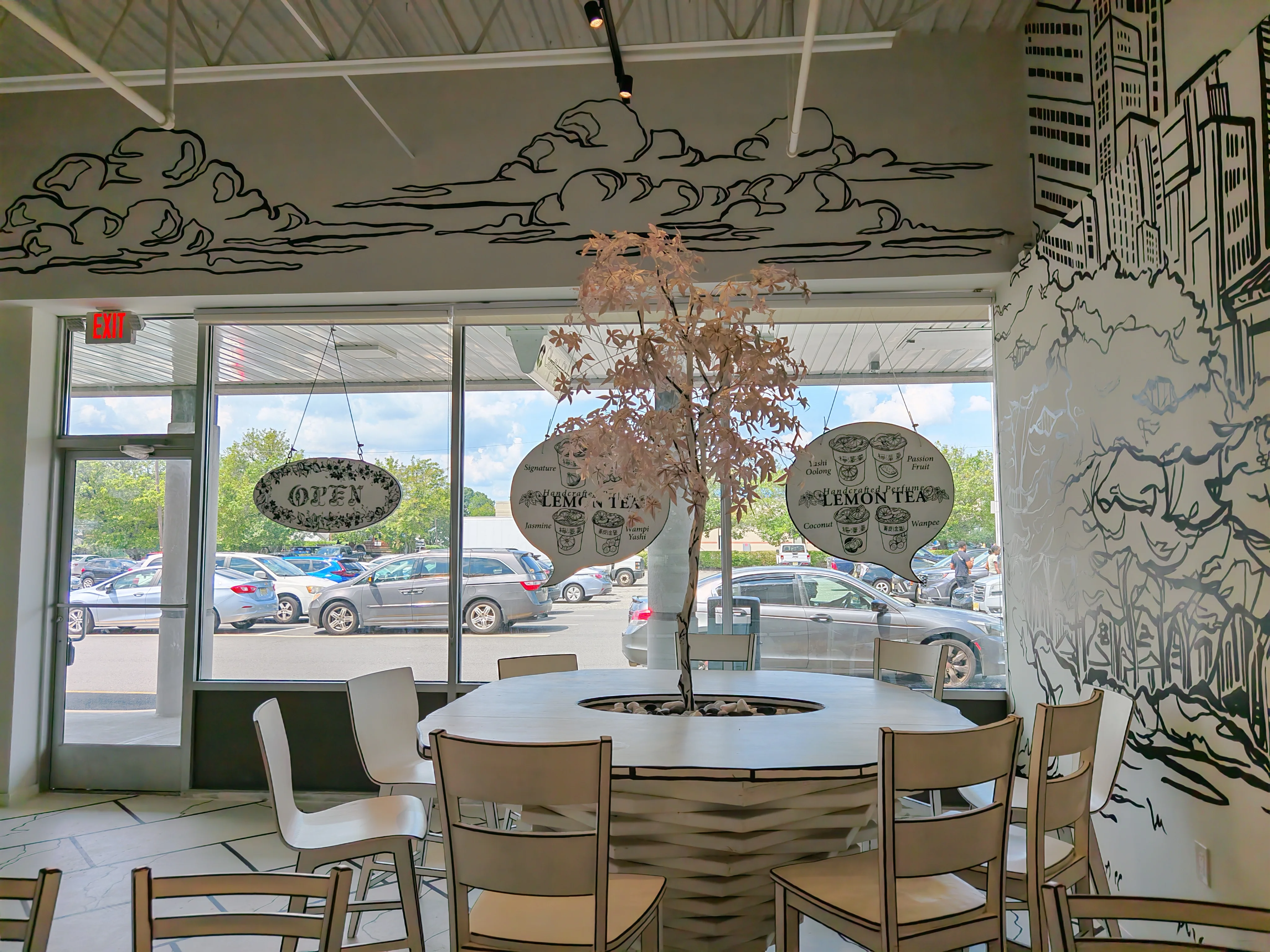  A unique dining table at Chopsticks Charm with a beautiful white, 2-D styled tree growing from its center.