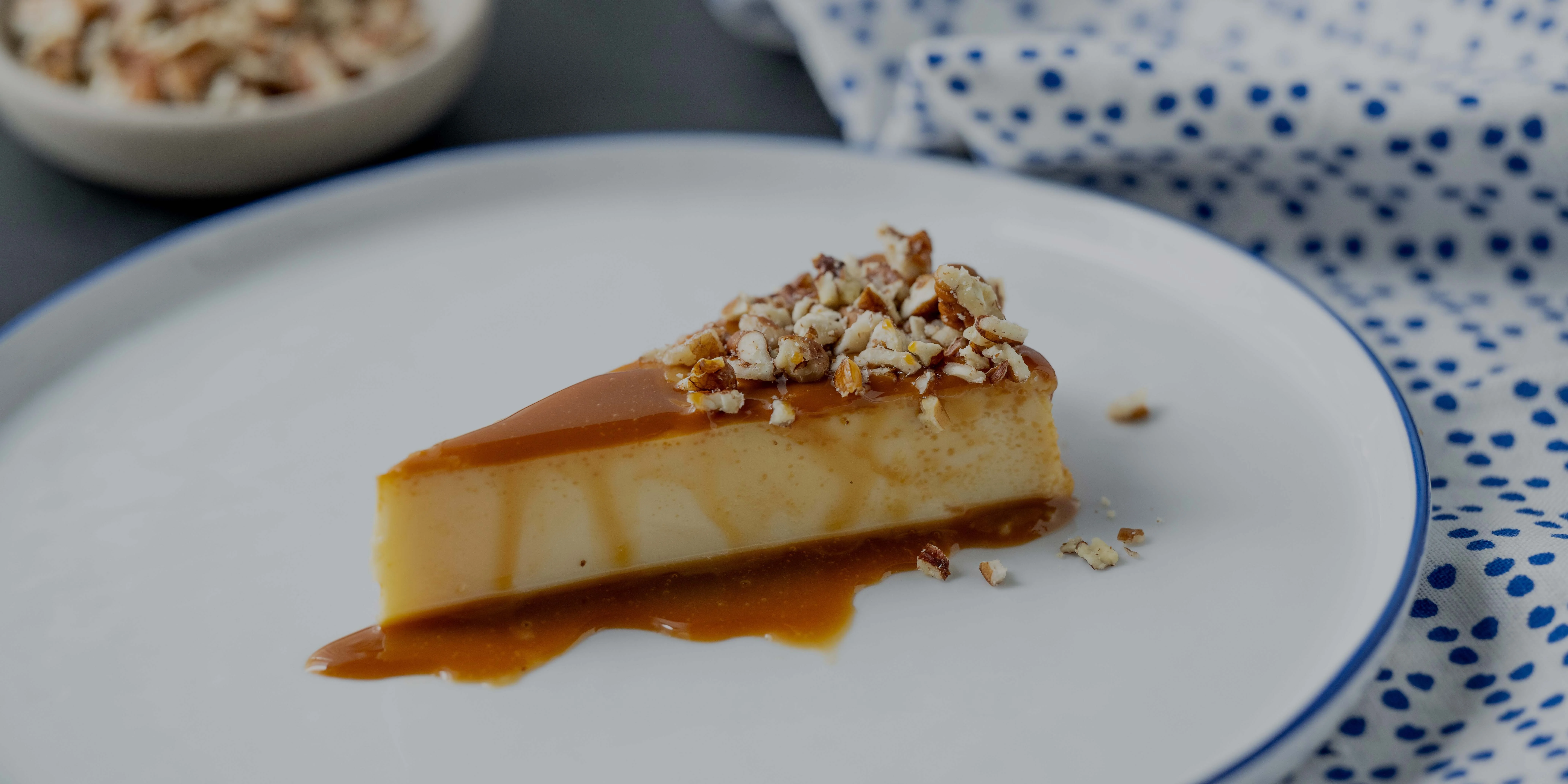 Creamy flan dessert topped with caramel and nuts