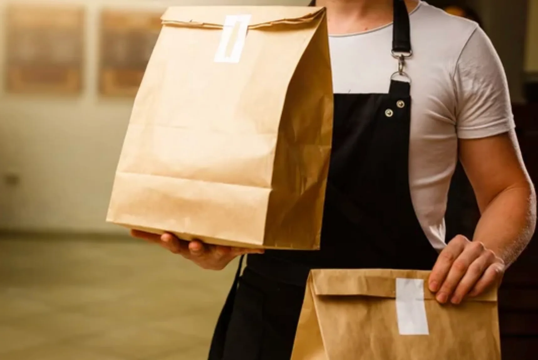 Image of our employees with Togo bags. Showing cleanliness and hospitality 