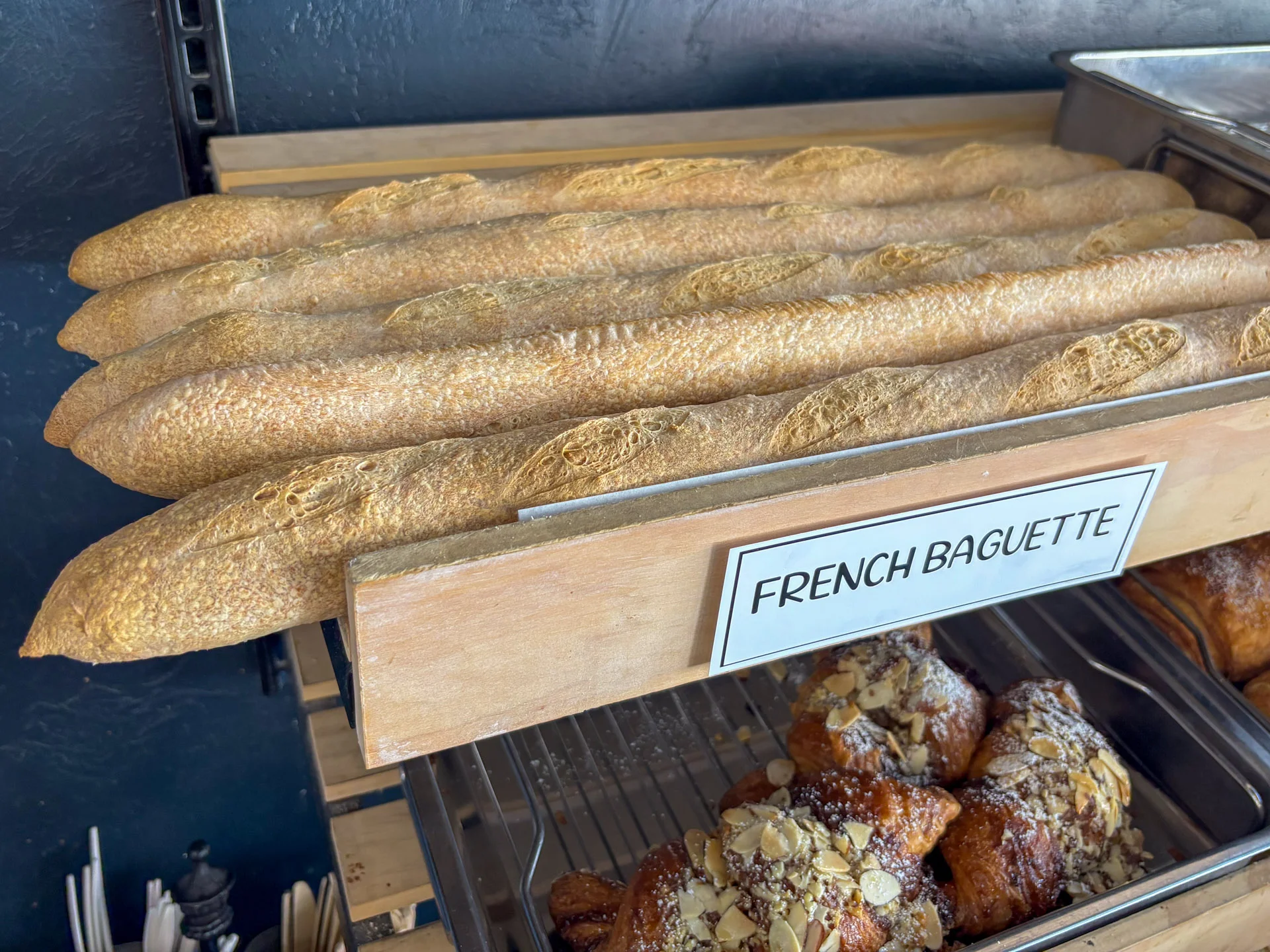 Freshly baked baguette on a wooden surface.