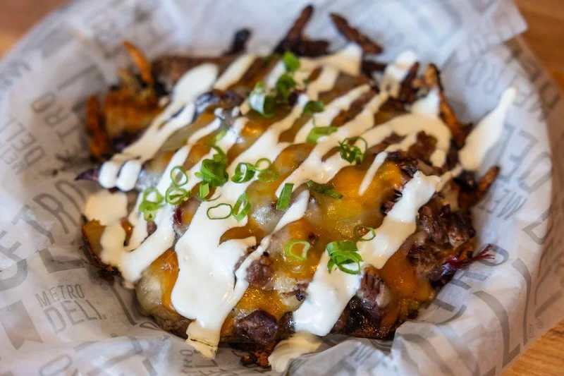 Loaded nachos topped with cheese and sour cream