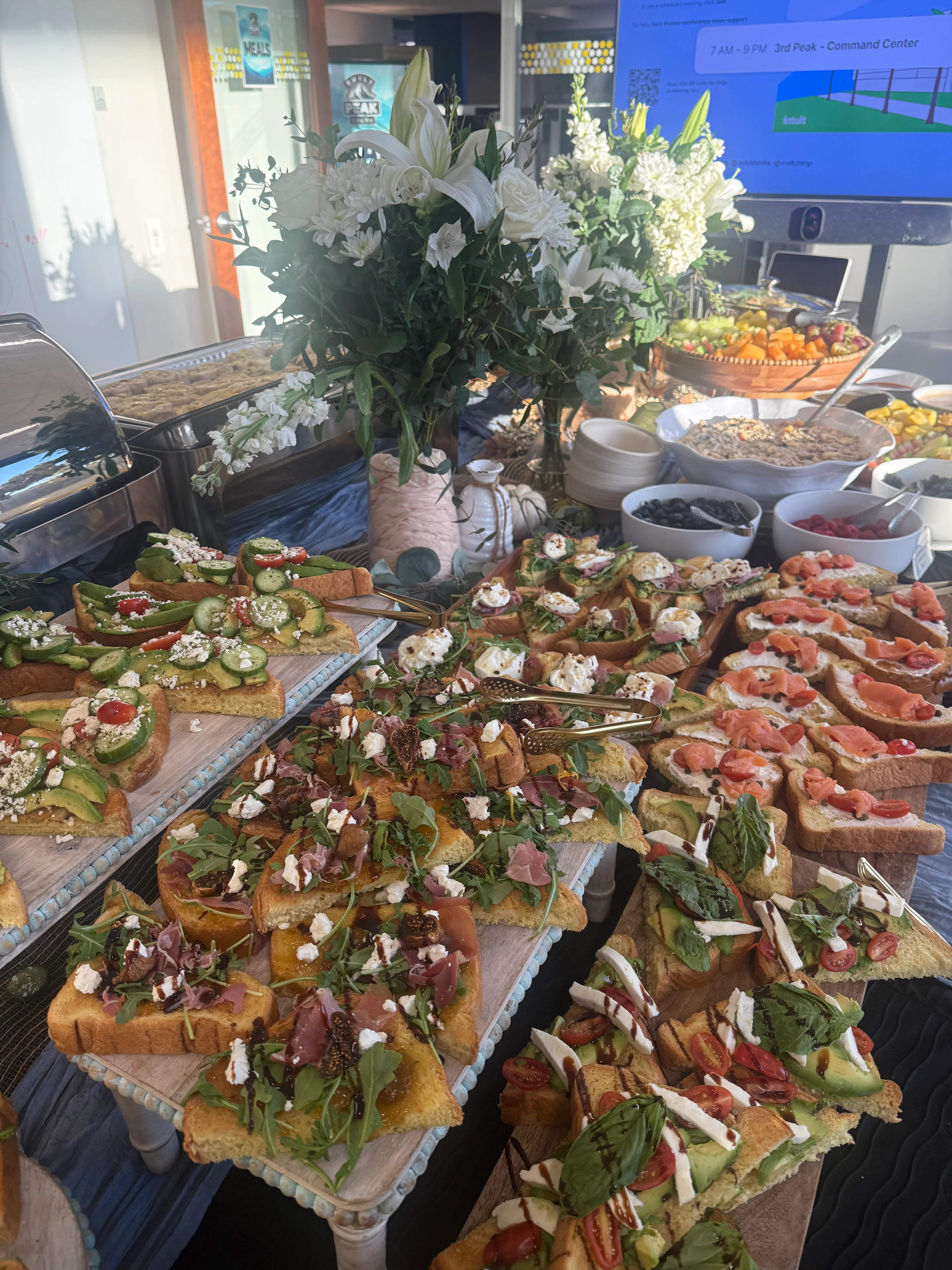 Catering spread of open-faced toasts and colorful hors d'oeuvres
