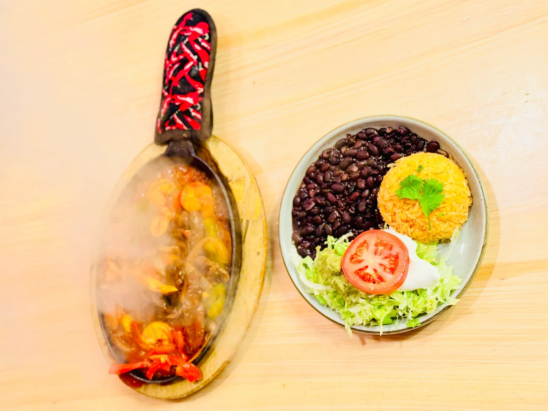 Sizzling fajitas served with rice and black beans