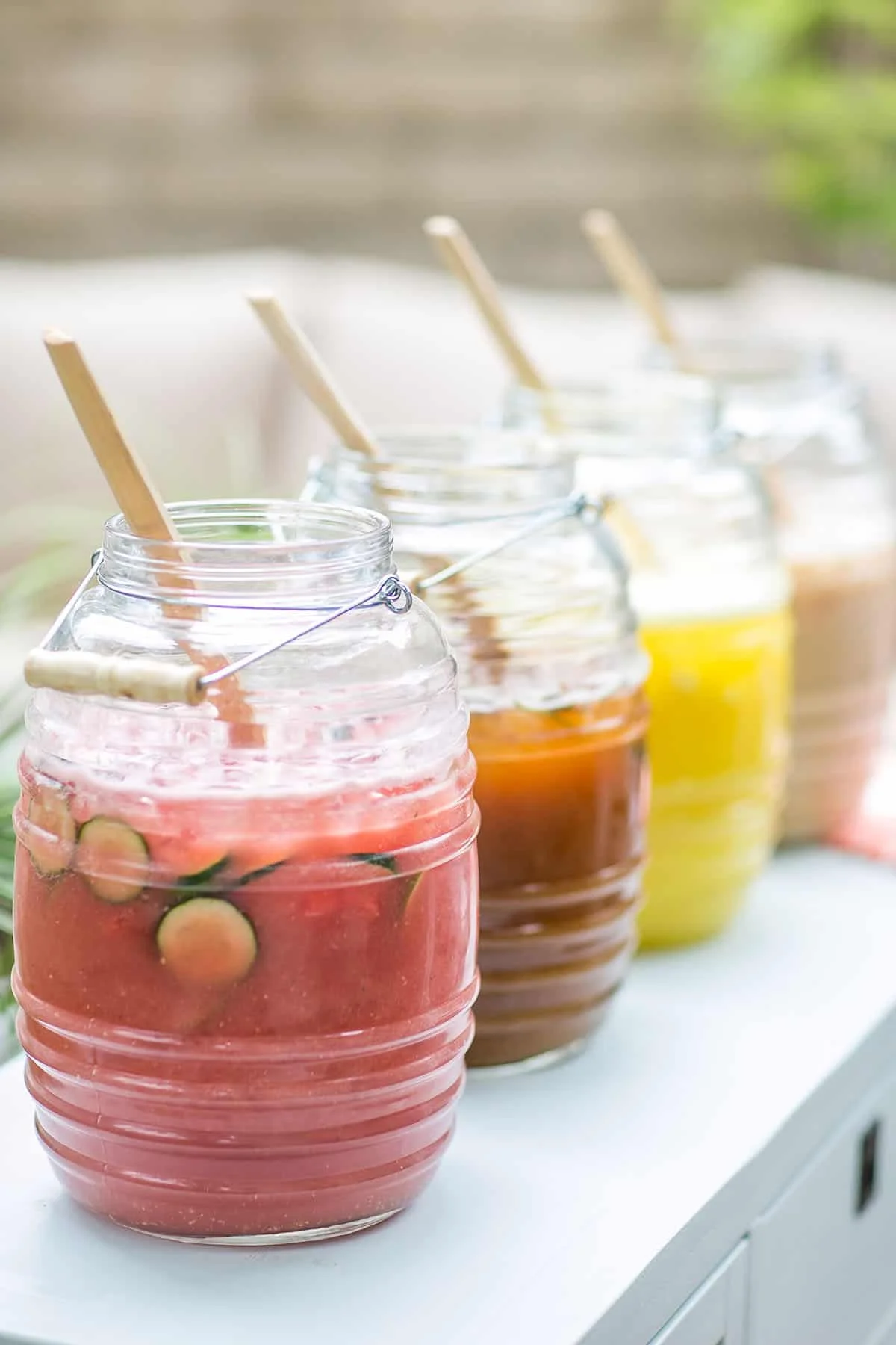 Colorful jars of refreshing fruit beverages on a table