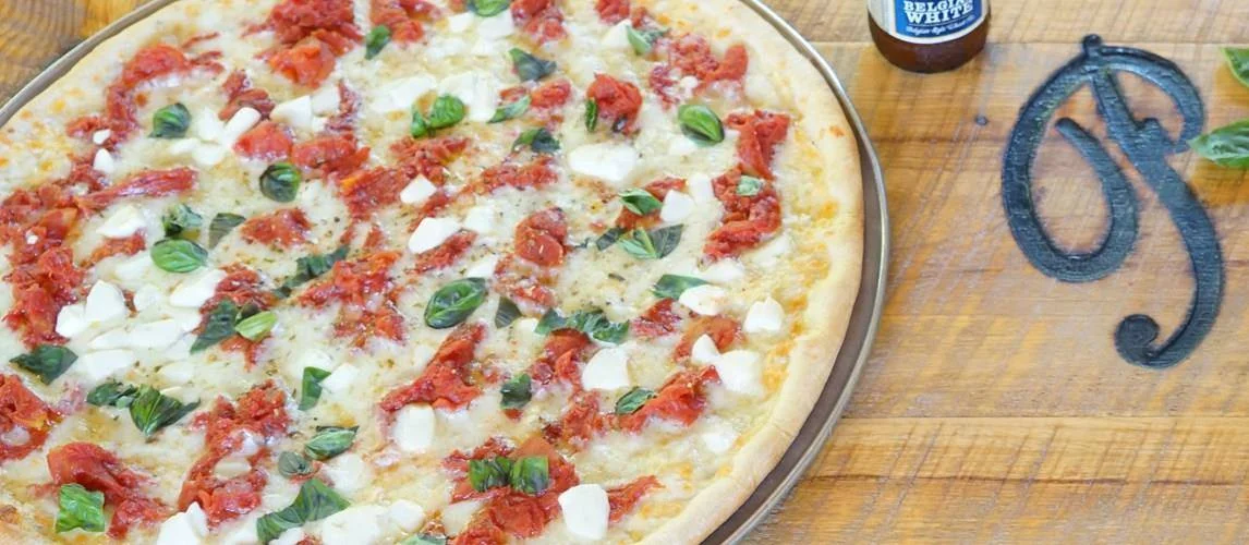 Sun-dried tomato pizza with fresh basil