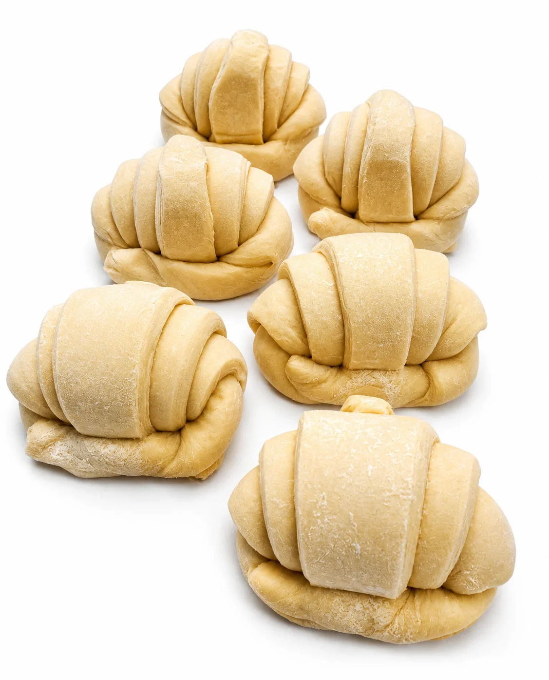 Raw croissant dough shaped and ready for baking.