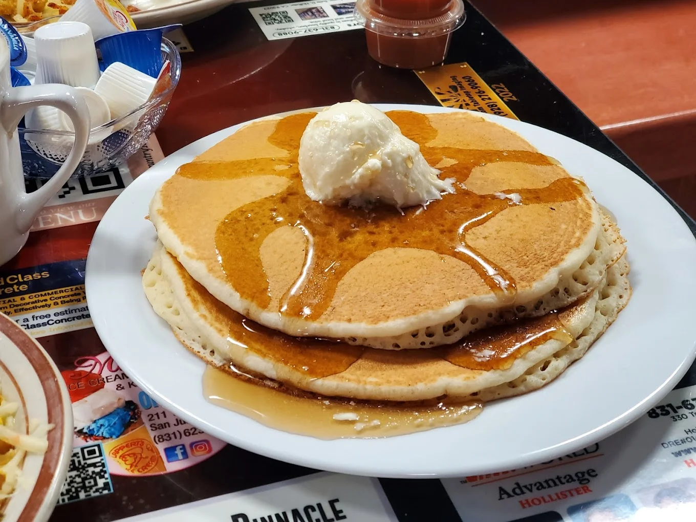 Fluffy buttermilk pancakes with syrup and butter