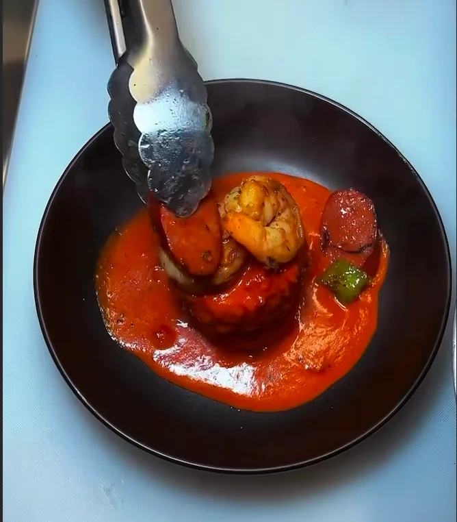 Cajun shrimp and sausage dish with rich tomato sauce