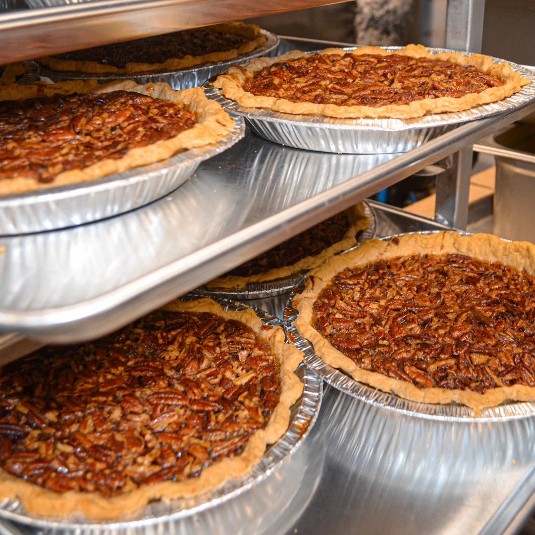 Freshly baked pecan pie cooling on a rack
