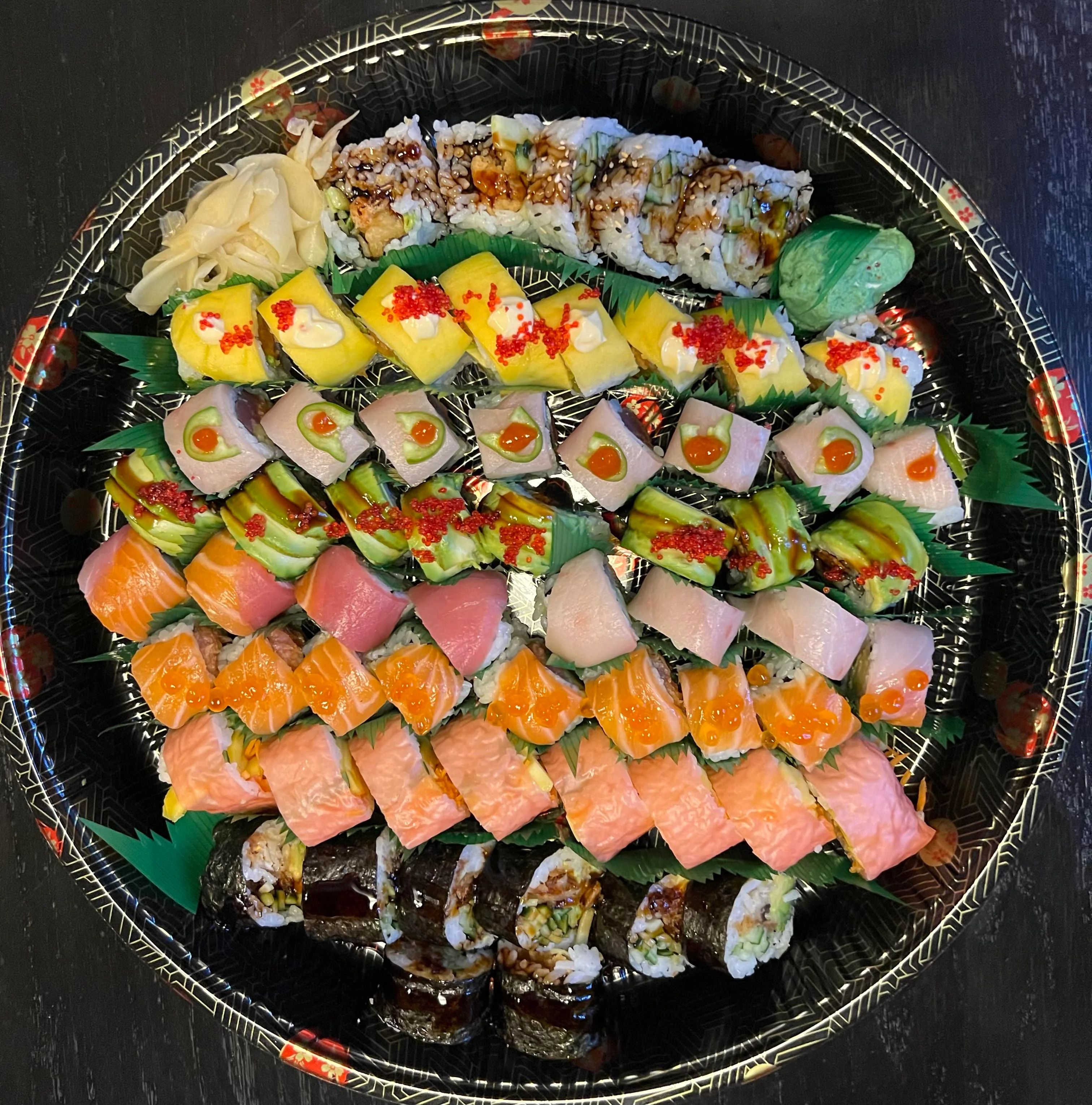 Assorted Japanese sushi platter with colorful rolls and garnishes