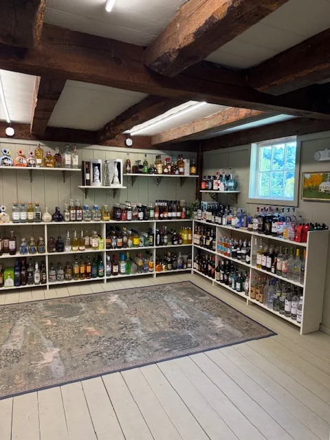 Well-organized liquor shelf in a rustic bar setting