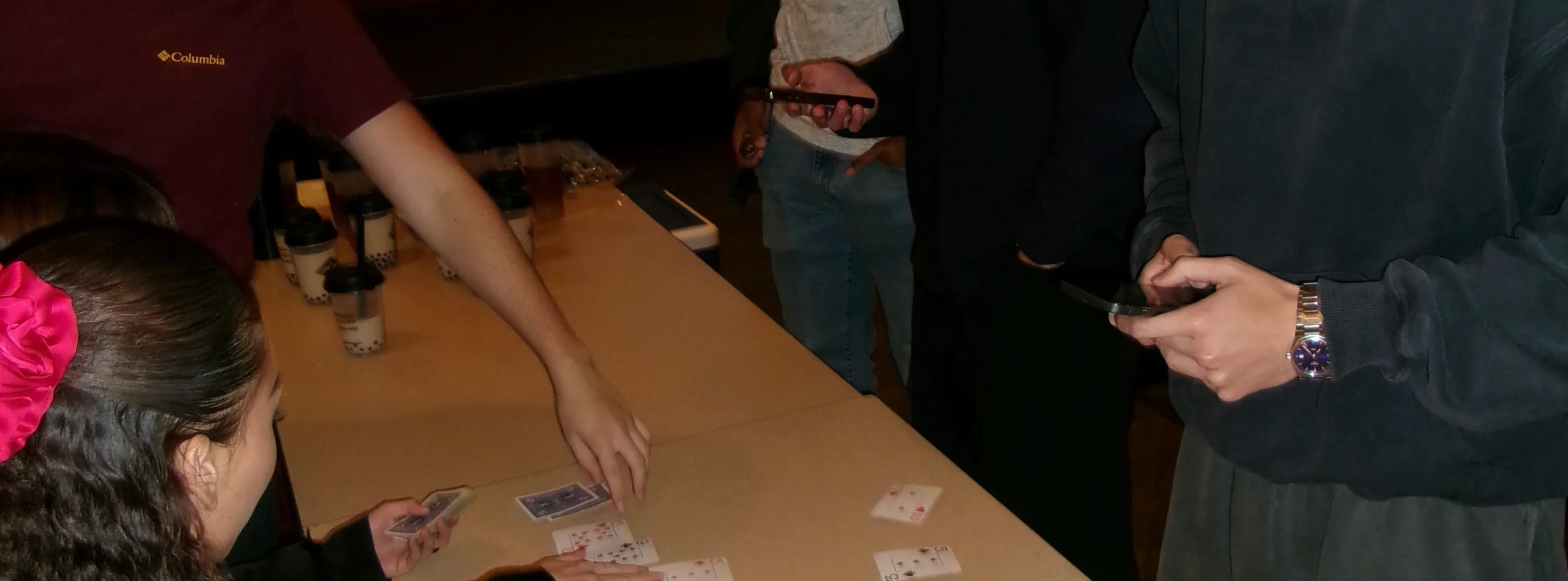 Group of friends playing cards at a table
