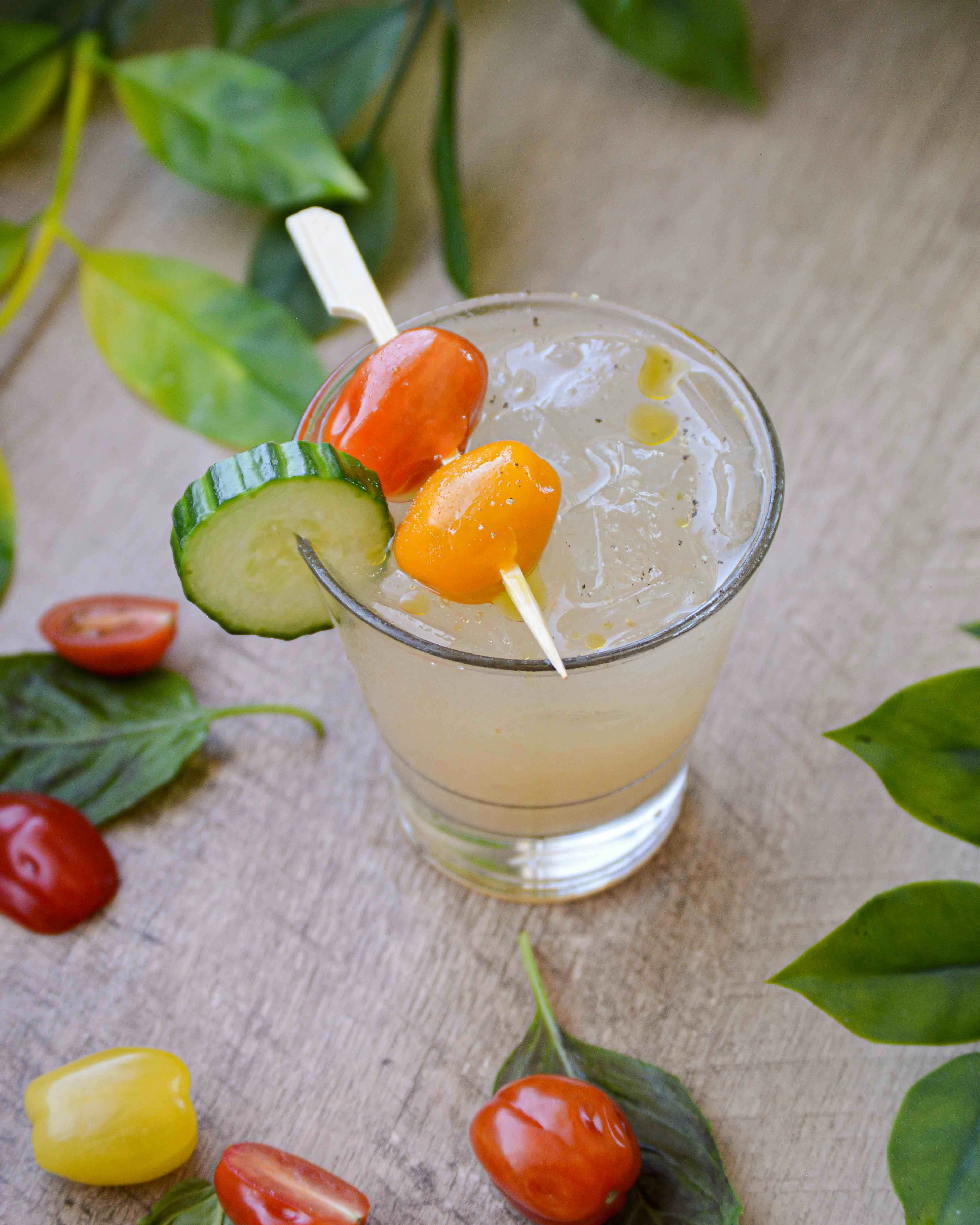 Garden Party cocktail with tomatoes and greenery around it