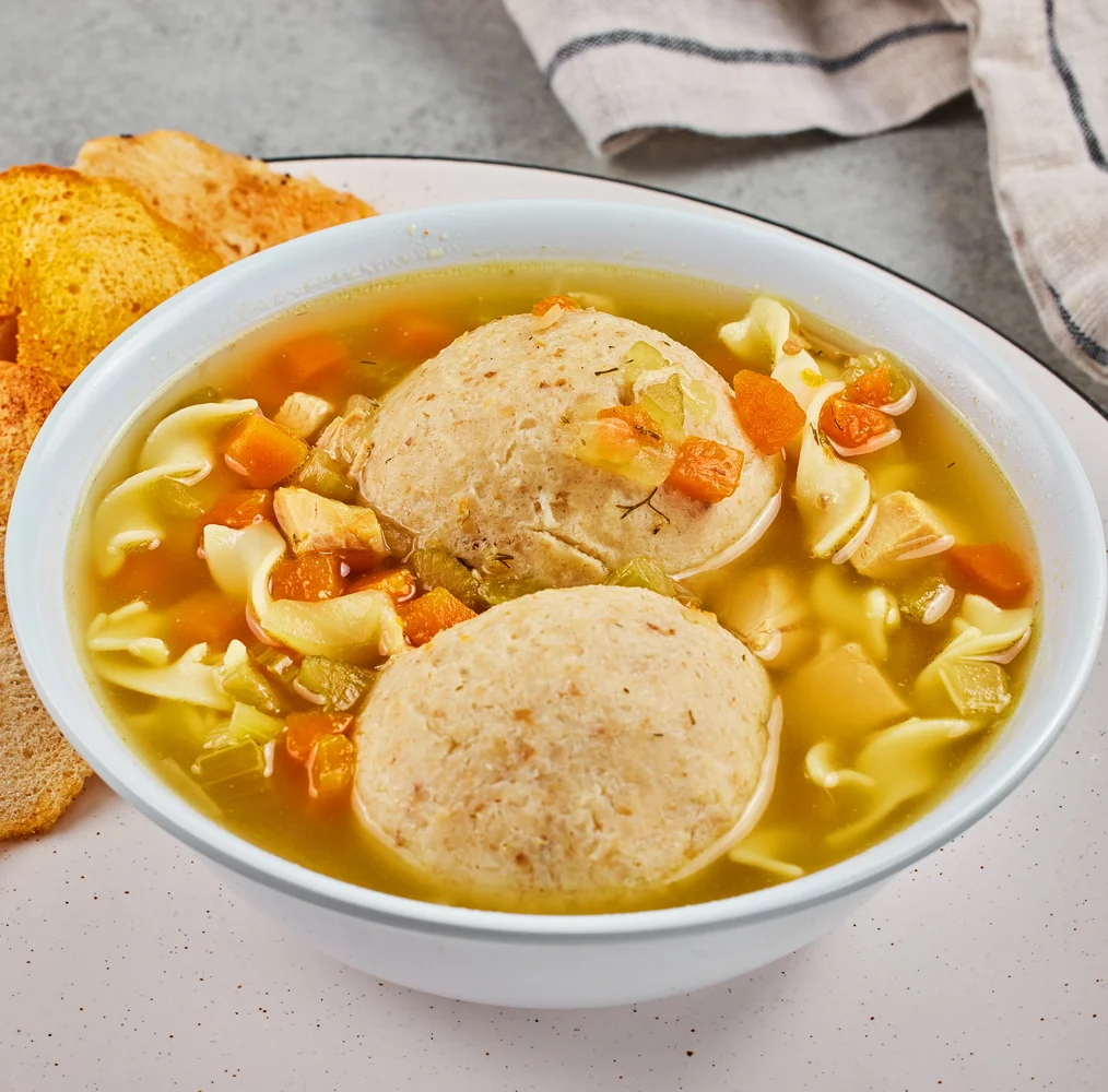 Chicken matzoh ball soup with noodles and vegetables