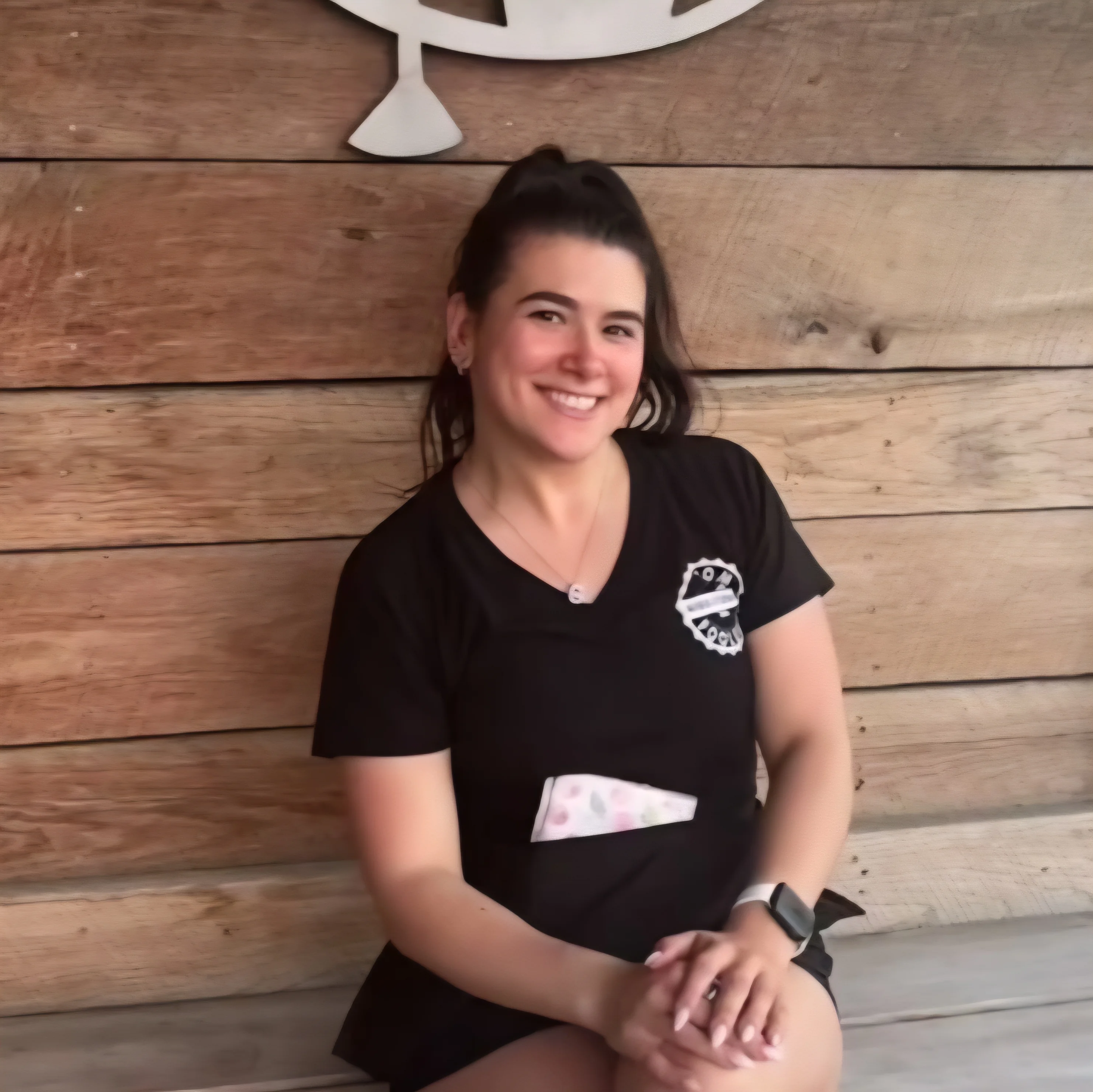 Smiling restaurant staff member in a cozy wooden setting