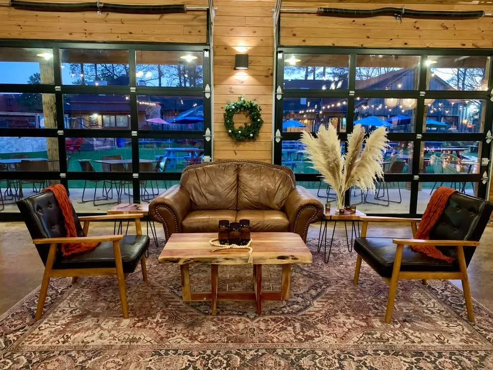 Cozy restaurant seating area with leather couch and rustic decor