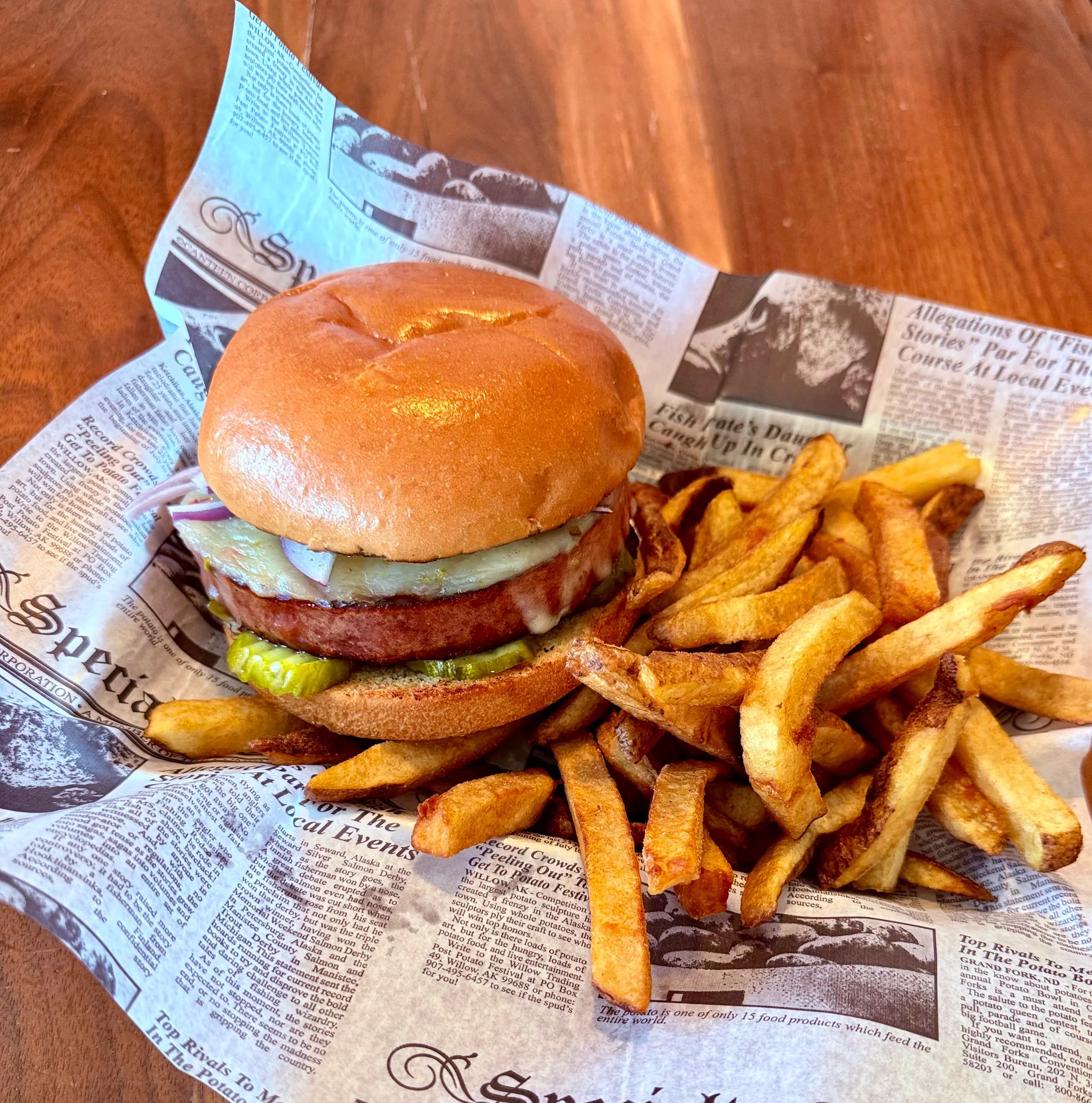 Delicious gourmet burger with fresh toppings on a wooden table